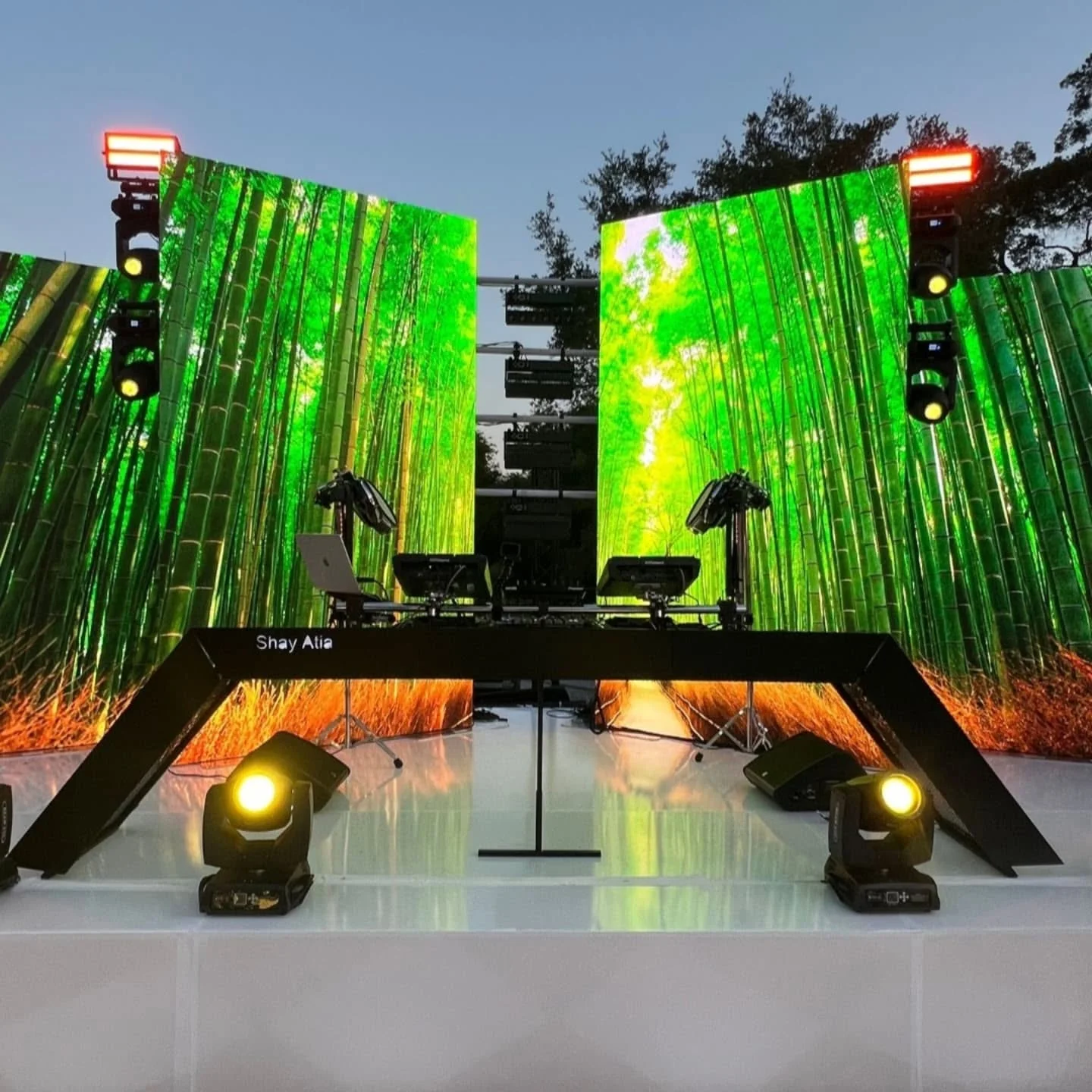 A sleek custom ARAMIN DJ booth setup in a modern event venue space.